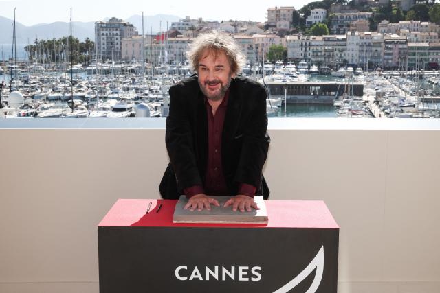 New Zealand director, screenwriter and producer Peter Jackson displays his handprints during an induction ceremony at the Cafe des Palmes at the Palais des Festivals during the 79th edition of the Cannes Film Festival in Cannes, southern France on May 13, 2026. (Photo by Valery HACHE / AFP)