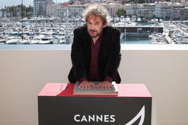 New Zealand director, screenwriter and producer Peter Jackson displays his handprints during an induction ceremony at the Cafe des Palmes at the Palais des Festivals during the 79th edition of the Cannes Film Festival in Cannes, southern France on May 13, 2026. (Photo by Valery HACHE / AFP)
