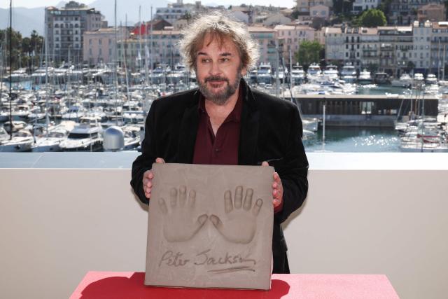 New Zealand director, screenwriter and producer Peter Jackson displays his handprints during an induction ceremony at the Cafe des Palmes at the Palais des Festivals during the 79th edition of the Cannes Film Festival in Cannes, southern France on May 13, 2026. (Photo by Valery HACHE / AFP)