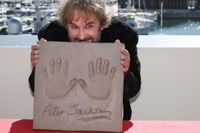 New Zealand director, screenwriter and producer Peter Jackson displays his handprints during an induction ceremony at the Cafe des Palmes at the Palais des Festivals during the 79th edition of the Cannes Film Festival in Cannes, southern France on May 13, 2026. (Photo by Valery HACHE / AFP)