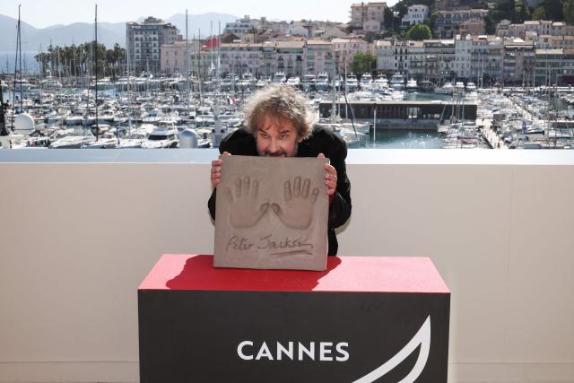 New Zealand director, screenwriter and producer Peter Jackson displays his handprints during an induction ceremony at the Cafe des Palmes at the Palais des Festivals during the 79th edition of the Cannes Film Festival in Cannes, southern France on May 13, 2026. (Photo by Valery HACHE / AFP)