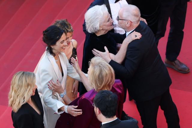 (From Top L) French actress Lea Drucker, French director Charline Bourgeois-Tacquet, French actress Melanie Thierry and French actress Marie-Christine Barrault embraces  Cannes film festival director Thierry Fremaux (bottom R) and German media executive and President of the Cannes Film Festival Iris Knobloch (bottom C) as they arrive for the screening of the film "La Vie d'une femme" (A Woman's Life) at the 79th edition of the Cannes Film Festival in Cannes, southern France on May 13, 2026. (Photo by Sameer AL-DOUMY / AFP)