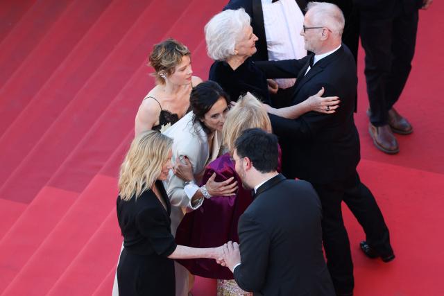 (From Top L) French actress Lea Drucker, French director Charline Bourgeois-Tacquet, French actress Melanie Thierry and French actress Marie-Christine Barrault embraces  Cannes film festival director Thierry Fremaux (bottom R) and German media executive and President of the Cannes Film Festival Iris Knobloch (bottom C) as they arrive for the screening of the film "La Vie d'une femme" (A Woman's Life) at the 79th edition of the Cannes Film Festival in Cannes, southern France on May 13, 2026. (Photo by Sameer AL-DOUMY / AFP)