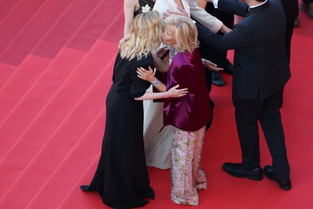 French actress Lea Drucker embraces German media executive and President of the Cannes Film Festival Iris Knobloch as they arrive for the screening of the film "La Vie d'une femme" (A Woman's Life) at the 79th edition of the Cannes Film Festival in Cannes, southern France on May 13, 2026. (Photo by Sameer AL-DOUMY / AFP)