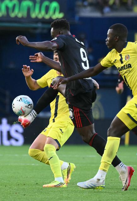 Sevilla's Nigerian forward #09 Akor Jerome Adams is challenged by Villarreal's Spanish forward #20 Alberto Moleiro (L) during the Spanish league football match between Villarreal CF and Sevilla FC at La Ceramica Stadium in Vila-real on May 12, 2026. (Photo by JOSE JORDAN / AFP)