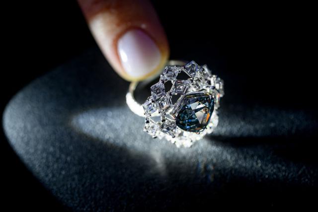 (FILES) A photograph taken on May 7, 2026 shows a triangular-shaped fancy vivid blue-green diamond weighing 5.50 carats, known as "The Ocean Dream", displayed during a press preview at Christie’s auction house in Geneva. A vivid blue-green diamond of 5.50 carats, the largest known to date, was sold for more than $17 million on Wednesday in Geneva, exceeding expectations, Christie's announced. (Photo by Fabrice COFFRINI / AFP)