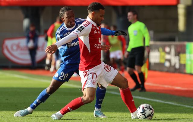 Brest's French defender #77 Kenny Lala (R) fights for the ball with Strasbourg's Ivorian forward #20 Martial Godo (L) during the French L1 football match between Stade Brestois 29 (Brest) and RC Strasbourg Alsace (RCSA) at the Francis-Le-Ble Stadium in Brest on May 13, 2026. (Photo by Fred TANNEAU / AFP)