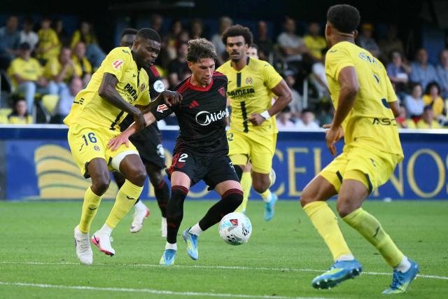 Villarreal's Ghanaian midfielder #16 Thomas Partey challenges Sevilla's Spanish defender #02 Jose Angel Carmona during the Spanish league football match between Villarreal CF and Sevilla FC at La Ceramica Stadium in Vila-real on May 12, 2026. (Photo by JOSE JORDAN / AFP)