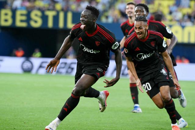 Sevilla's Nigerian forward #09 Akor Jerome Adams (L) celebrates scoring his team's third goal during the Spanish league football match between Villarreal CF and Sevilla FC at La Ceramica Stadium in Vila-real on May 12, 2026. (Photo by JOSE JORDAN / AFP)