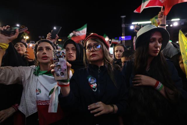 People gather to attend the farewell ceremony of Iran's national football team ahead of their departure for the 2026 FIFA World Cup, in Tehran on May 13, 2026. The president of the Iranian Football Federation said late May 9 that if Iran dropped out of the World Cup, it would deprive the country of a "major diplomatic asset". World football's governing body FIFA has insisted for weeks that Iran will take part. Iran, who are due to be based in Tucson, Arizona, during the World Cup, face New Zealand, Belgium and Egypt in Group G. The Iranians open their World Cup campaign against New Zealand in Los Angeles on June 15. (Photo by ATTA KENARE / AFP)