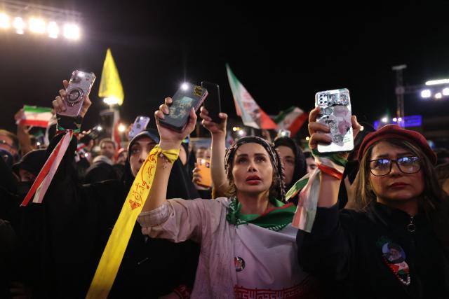 People gather to attend the farewell ceremony of Iran's national football team ahead of their departure for the 2026 FIFA World Cup, in Tehran on May 13, 2026. The president of the Iranian Football Federation said late May 9 that if Iran dropped out of the World Cup, it would deprive the country of a "major diplomatic asset". World football's governing body FIFA has insisted for weeks that Iran will take part. Iran, who are due to be based in Tucson, Arizona, during the World Cup, face New Zealand, Belgium and Egypt in Group G. The Iranians open their World Cup campaign against New Zealand in Los Angeles on June 15. (Photo by ATTA KENARE / AFP)