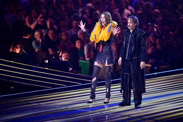 Austrian presenters Victoria Swarovski and Michael Ostrowski greet the audience during a dress rehearsal for the second semi-final of the Eurovision Song Contest 2026 (ESC) at Wiener Stadthalle in Vienna, Austria on May 13, 2026. (Photo by Tobias SCHWARZ / AFP)