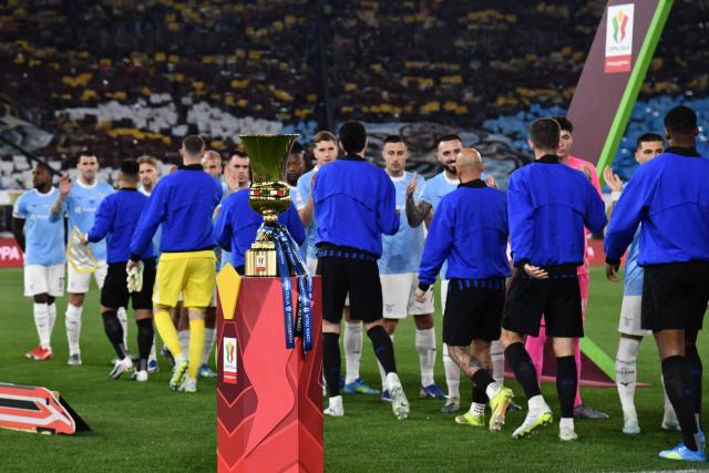 The winner's trophy is displayed as players greet each other prior to the Italian Cup (Coppa Italia) final football match between Lazio Rome and Inter Milan at the Olympic stadium in Rome on May 13, 2026. (Photo by Isabella BONOTTO / AFP)