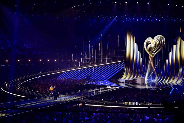 Austrian presenters Victoria Swarovski and Michael Ostrowski greet the audience during a dress rehearsal for the second semi-final of the Eurovision Song Contest 2026 (ESC) at Wiener Stadthalle in Vienna, Austria on May 13, 2026. (Photo by Tobias SCHWARZ / AFP)