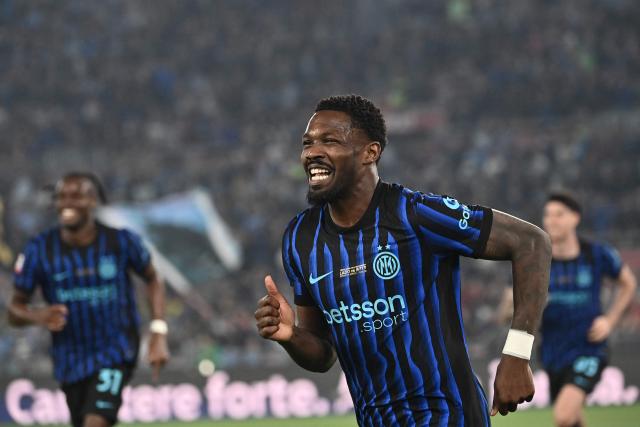 Inter Milan's French forward #09 Marcus Thuram celebrates after Lazio scored an own goal to open the scoring during the Italian Cup (Coppa Italia) final football match between Lazio Rome and Inter Milan at the Olympic stadium in Rome on May 13, 2026. (Photo by Isabella BONOTTO / AFP)