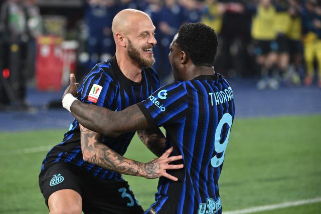 Inter Milan's French forward #09 Marcus Thuram (R) celebrates with Inter Milan's Italian defender #32 Federico Dimarco after Lazio scored an own goal to open the scoring during the Italian Cup (Coppa Italia) final football match between Lazio Rome and Inter Milan at the Olympic stadium in Rome on May 13, 2026. (Photo by Isabella BONOTTO / AFP)