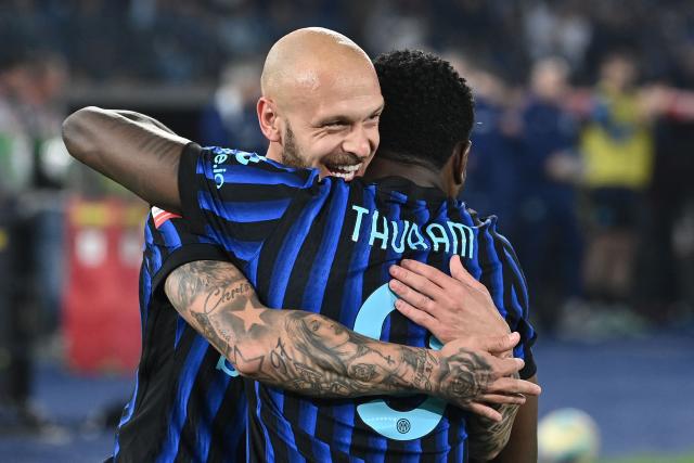 Inter Milan's French forward #09 Marcus Thuram (R) celebrates with Inter Milan's Italian defender #32 Federico Dimarco after Lazio scored an own goal to open the scoring during the Italian Cup (Coppa Italia) final football match between Lazio Rome and Inter Milan at the Olympic stadium in Rome on May 13, 2026. (Photo by Isabella BONOTTO / AFP)
