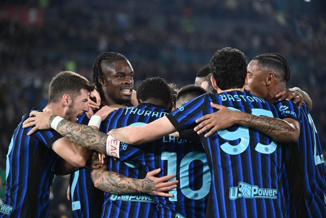 Inter players celebrate after opening the scoring during the Italian Cup (Coppa Italia) final football match between Lazio Rome and Inter Milan at the Olympic stadium in Rome on May 13, 2026. (Photo by Isabella BONOTTO / AFP)