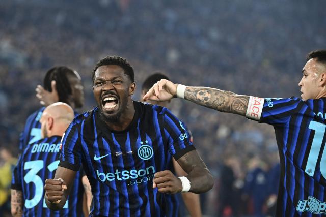 Inter Milan's French forward #09 Marcus Thuram (L) celebrates after Lazio scored an own goal to open the scoring during the Italian Cup (Coppa Italia) final football match between Lazio Rome and Inter Milan at the Olympic stadium in Rome on May 13, 2026. (Photo by Isabella BONOTTO / AFP)