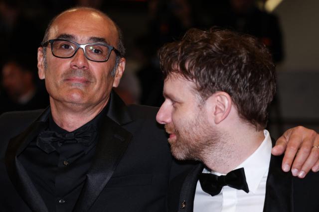 French director and screenwriter Vincent Garenq (L) and French actor Antoine Reinartz arrive for the screening of the film "L'Abandon" at the 79th edition of the Cannes Film Festival in Cannes, southern France on May 13, 2026. (Photo by Valery HACHE / AFP)