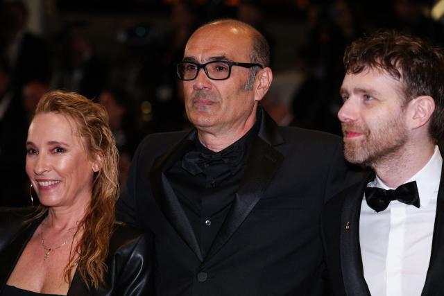 (From L) French actress Emmanuelle Bercot, French director and screenwriter Vincent Garenq and French actor Antoine Reinartz arrive for the screening of the film "L'Abandon" at the 79th edition of the Cannes Film Festival in Cannes, southern France on May 13, 2026. (Photo by Valery HACHE / AFP)
