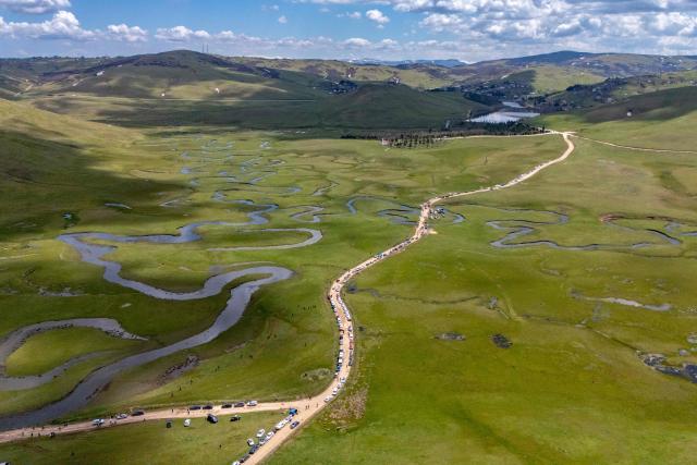 This aerial view shows vehicles parked along a dirt road during a protest march against mining at the Aybasti Plateau in Ordu Province, northeastern Turkey, on May 8, 2026. With Turkey hosting COP31 in November 2026, its own environmental record is being scrutinised, with activists warning about the growing number of water-intensive mining projects as resources dry up. (Photo by Yasin AKGUL / AFP) / TO GO WITH AFP STORY by BURC?N GERCEK