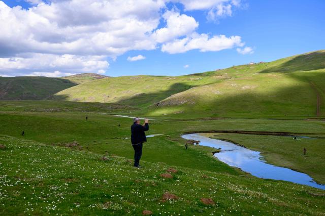 A man takes a picture at the Aybasti Plateau in Ordu Province, northeastern Turkey, on May 8, 2026. With Turkey hosting COP31 in November 2026, its own environmental record is being scrutinised, with activists warning about the growing number of water-intensive mining projects as resources dry up. (Photo by Yasin AKGUL / AFP) / TO GO WITH AFP STORY by BURC?N GERCEK
