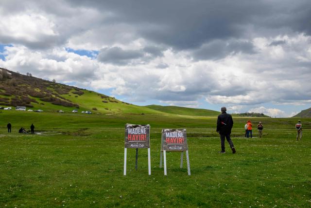 Protesters stand next to placards reading “No to the mine” during a protest march against mining at the Aybasti Plateau in Ordu Province, northeastern Turkey, on May 8, 2026. With Turkey hosting COP31 in November 2026, its own environmental record is being scrutinised, with activists warning about the growing number of water-intensive mining projects as resources dry up. (Photo by Yasin AKGUL / AFP) / TO GO WITH AFP STORY by BURC?N GERCEK