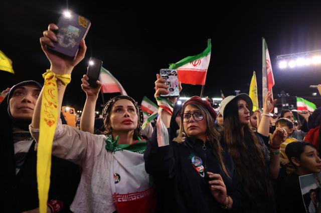People gather to attend the farewell ceremony of Iran's national football team ahead of their departure for the 2026 FIFA World Cup, in Tehran on May 13, 2026. The president of the Iranian Football Federation said late May 9 that if Iran dropped out of the World Cup, it would deprive the country of a "major diplomatic asset". World football's governing body FIFA has insisted for weeks that Iran will take part. Iran, who are due to be based in Tucson, Arizona, during the World Cup, face New Zealand, Belgium and Egypt in Group G. The Iranians open their World Cup campaign against New Zealand in Los Angeles on June 15. (Photo by ATTA KENARE / AFP)