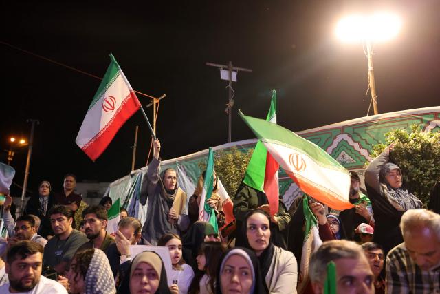 People gather to attend the farewell ceremony of Iran's national football team ahead of their departure for the 2026 FIFA World Cup, in Tehran on May 13, 2026. The president of the Iranian Football Federation said late May 9 that if Iran dropped out of the World Cup, it would deprive the country of a "major diplomatic asset". World football's governing body FIFA has insisted for weeks that Iran will take part. Iran, who are due to be based in Tucson, Arizona, during the World Cup, face New Zealand, Belgium and Egypt in Group G. The Iranians open their World Cup campaign against New Zealand in Los Angeles on June 15. (Photo by ATTA KENARE / AFP) / 