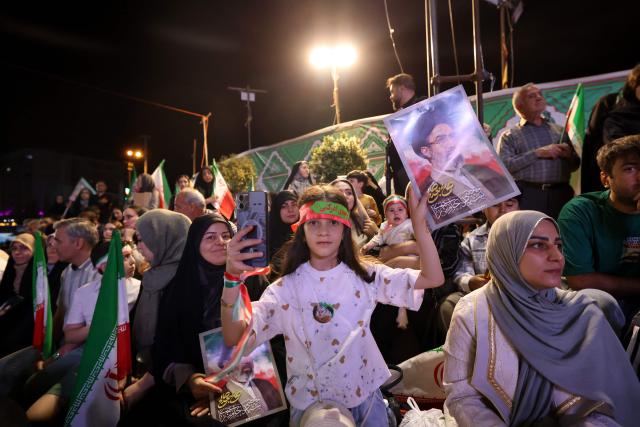 People gather to attend the farewell ceremony of Iran's national football team ahead of their departure for the 2026 FIFA World Cup, in Tehran on May 13, 2026. The president of the Iranian Football Federation said late May 9 that if Iran dropped out of the World Cup, it would deprive the country of a "major diplomatic asset". World football's governing body FIFA has insisted for weeks that Iran will take part. Iran, who are due to be based in Tucson, Arizona, during the World Cup, face New Zealand, Belgium and Egypt in Group G. The Iranians open their World Cup campaign against New Zealand in Los Angeles on June 15. (Photo by ATTA KENARE / AFP) / 
