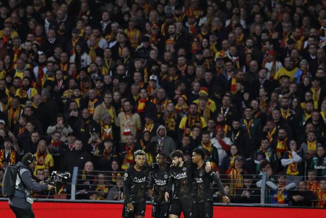 Paris Saint-Germain's Georgian forward #07 Khvicha Kvaratskhelia (2ndR) is congratulated by teammates after scoring a goal during the French L1 football match between RC Lens and Paris Saint-Germain (PSG) at the Stade Bollaert-Delelis stadium in Lens on May 13, 2026. (Photo by SIMON WOHLFAHRT / AFP)