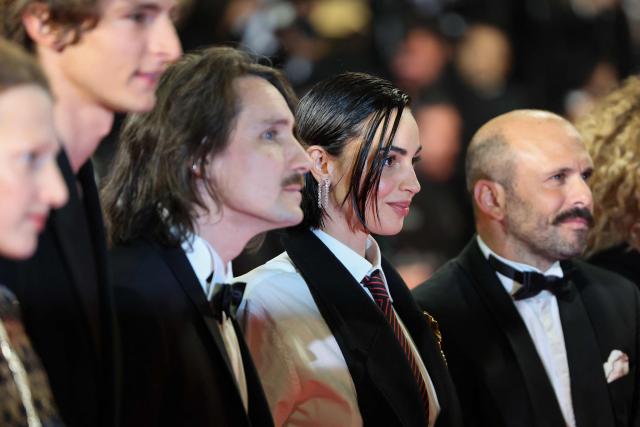 Swiss actress Souheila Yacoub poses with French actor Vassili Schneider (2ndL), French director Berenger Thouin (3rdL)and French actor Pierre-Antoine Billon (R) as they arrive for the screening of the film "L'Age d'or" (The Golden Age) at the 79th edition of the Cannes Film Festival in Cannes, southern France on May 13, 2026. (Photo by Thibaud MORITZ / AFP)