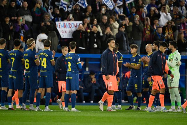 Alaves players form a guard of honour for the Barcelona players before the Spanish league football match between Deportivo Alaves and FC Barcelona at Mendizorroza Stadium in Vitoria on May 13, 2026. (Photo by ANDER GILLENEA / AFP)