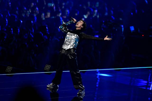 Austrian singer Benjamin Gedeon, aka Cosmo and representing Austria with the song 'Tanzschein', performs during a dress rehearsal for the second semi-final of the Eurovision Song Contest 2026 (ESC) at Wiener Stadthalle in Vienna, Austria on May 13, 2026. (Photo by Tobias SCHWARZ / AFP)