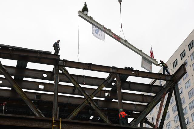 A steel beam signed by construction workers and guests is lifted into place during the topping-out ceremony for The Broad Museum expansion in downtown Los Angeles on May 13, 2026. The art museum expansion is scheduled to be completed before the 2028 Summer Olympic and Paralympic Games. (Photo by Patrick T. Fallon / AFP)
