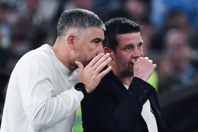 Inter's assistant coach Aleksandar Kolarov (L) speaks to Inter Milan's Romanian head coach Cristian Chivu during the Italian Cup (Coppa Italia) final football match between Lazio Rome and Inter Milan at the Olympic stadium in Rome on May 13, 2026. (Photo by Isabella BONOTTO / AFP)
