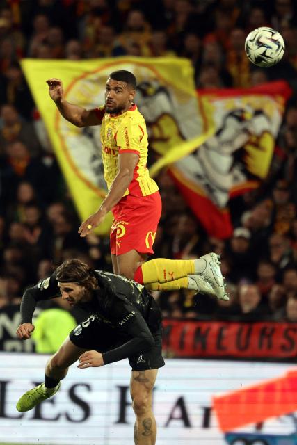 Lens' French defender #14 Matthieu Udol (up) fights for the ball with Paris Saint-Germain's Ukrainian defender #06 Illia Zabarnyi during the French L1 football match between RC Lens and Paris Saint-Germain (PSG) at the Stade Bollaert-Delelis stadium in Lens on May 13, 2026. (Photo by Francois LO PRESTI / AFP)