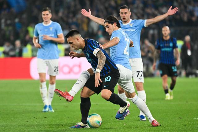 Lazio's Italian forward Matteo Cancellieri (C) tackles Inter Milan's Argentine forward #10 Lautaro Martinez as Lazio's Montenegrin defender #77 Adam Marusic (R) reacts during the Italian Cup (Coppa Italia) final football match between Lazio Rome and Inter Milan at the Olympic stadium in Rome on May 13, 2026. (Photo by Alberto PIZZOLI / AFP)