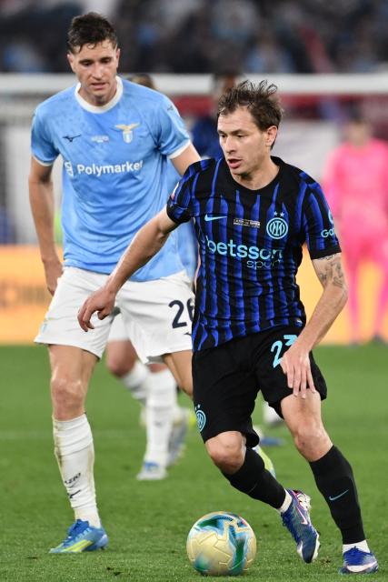 Inter Milan's Italian midfielder #23 Nicolo Barella (R) challenges Lazio's Croatian midfielder #26 Toma Basic during the Italian Cup (Coppa Italia) final football match between Lazio Rome and Inter Milan at the Olympic stadium in Rome on May 13, 2026. (Photo by Isabella BONOTTO / AFP)