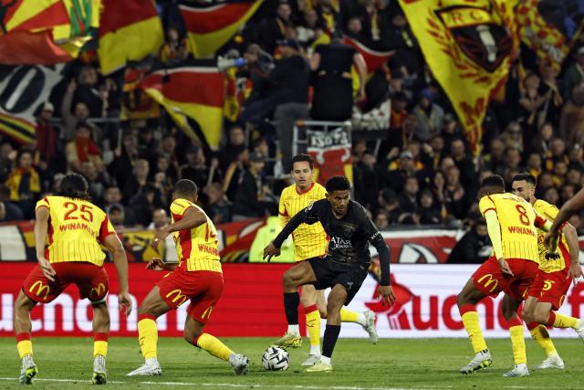 Paris Saint-Germain's French midfielder #24 Senny Mayulu (C) controls the ball during the French L1 football match between RC Lens and Paris Saint-Germain (PSG) at the Stade Bollaert-Delelis stadium in Lens on May 13, 2026. (Photo by SIMON WOHLFAHRT / AFP)