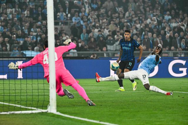 Inter Milan's Brazilian forward #11 Luis Henrique (Rear C) attempts to score past Lazio's Italian goalkeeper #40 Edoardo Motta (L) despite Lazio's Portuguese defender #17 Nuno Tavares during the Italian Cup (Coppa Italia) final football match between Lazio Rome and Inter Milan at the Olympic stadium in Rome on May 13, 2026. (Photo by Alberto PIZZOLI / AFP)