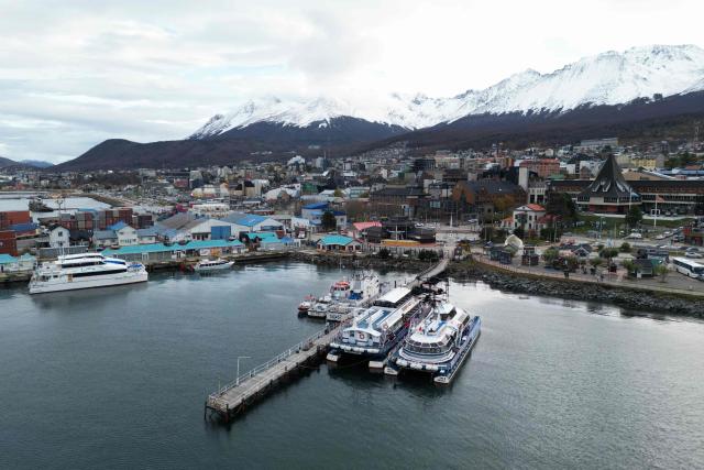 Aerial view of Ushuaia harbour in Tierra del Fuego, Argentina, on May 13, 2026. An emblematic tourist destination at the "end of the world," the Argentine city of Ushuaia is seeking to shed the label of the “origin” of the hantavirus outbreak aboard the MV Hondius cruise ship, which departed from there on April 1. (Photo by EDRIEN ESTEVES / AFP)
