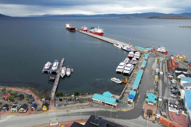 Aerial view of Ushuaia harbour in Tierra del Fuego, Argentina, on May 13, 2026. An emblematic tourist destination at the "end of the world," the Argentine city of Ushuaia is seeking to shed the label of the “origin” of the hantavirus outbreak aboard the MV Hondius cruise ship, which departed from there on April 1. (Photo by EDRIEN ESTEVES / AFP)