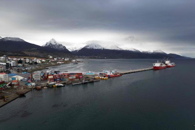 Aerial view of Ushuaia harbour in Tierra del Fuego, Argentina, on May 13, 2026. An emblematic tourist destination at the "end of the world," the Argentine city of Ushuaia is seeking to shed the label of the “origin” of the hantavirus outbreak aboard the MV Hondius cruise ship, which departed from there on April 1. (Photo by EDRIEN ESTEVES / AFP)