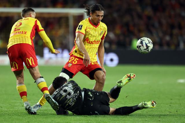 Lens' French defender #02 Ruben Aguilar (L) and Lens' French defender Pierre Ismaelo Ganiou (C, up) fight for the ball with Paris Saint-Germain's Portuguese forward #09 Goncalo Ramos (down) during the French L1 football match between RC Lens and Paris Saint-Germain (PSG) at the Stade Bollaert-Delelis stadium in Lens on May 13, 2026. (Photo by Francois LO PRESTI / AFP)
