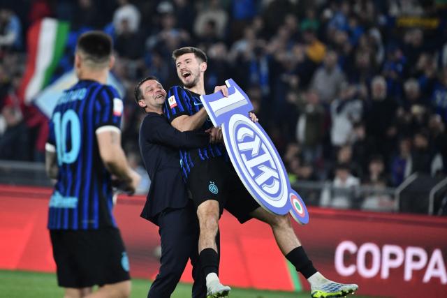 Inter Milan's Romanian head coach Cristian Chivu (C) and Inter Milan's Croatian midfielder #08 Petar Sucic celebrate after winning the Italian Cup (Coppa Italia) final football match between Lazio Rome and Inter Milan at the Olympic stadium in Rome on May 13, 2026. (Photo by Isabella BONOTTO / AFP)