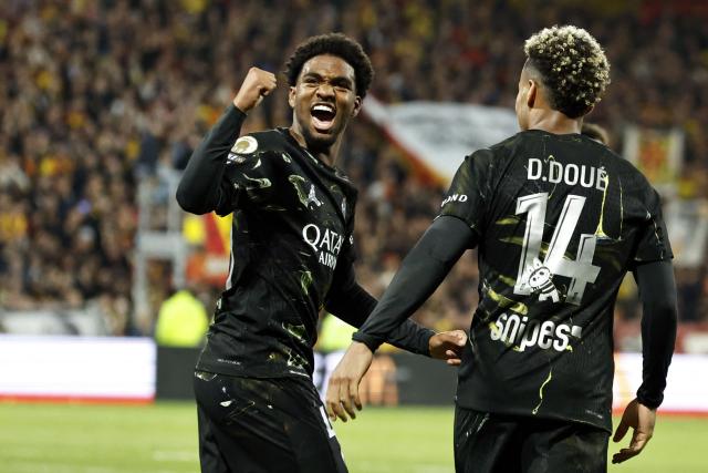 Paris Saint-Germain's French forward #49 Ibrahim Mbaye celebrates after scoring a goal during the French L1 football match between RC Lens and Paris Saint-Germain (PSG) at the Stade Bollaert-Delelis stadium in Lens on May 13, 2026. (Photo by SIMON WOHLFAHRT / AFP)