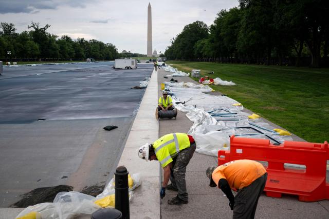 Workers install a tube like material along the walking path of the Lincoln Memorial Reflecting Pool as it is being resurfaced in Washington, DC, on May 13, 2026. Workers have been resurfacing the bottom of Washington's famous Lincoln Memorial Reflecting Pool with "American flag blue"-colored material used in swimming pools, following an order by US President Donald Trump. (Photo by Kent Nishimura / AFP)