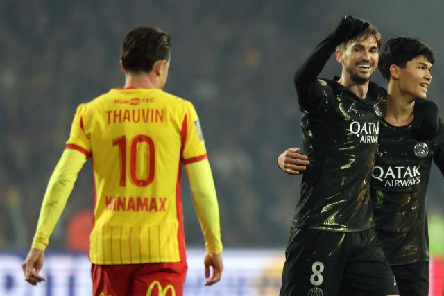 Paris Saint-Germain's Spanish midfielder #08 Fabian Ruiz (2ndR) celebrates next to Lens' French forward #10 Florian Thauvin at the end of the French L1 football match between RC Lens and Paris Saint-Germain (PSG) at the Stade Bollaert-Delelis stadium in Lens on May 13, 2026. (Photo by Francois LO PRESTI / AFP)